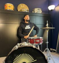 Load image into Gallery viewer, Stay warm in the 'JUST DRUM' hoodie. A cozy choice for drummers, percussionists, and drumline enthusiasts who love stylish comfort.