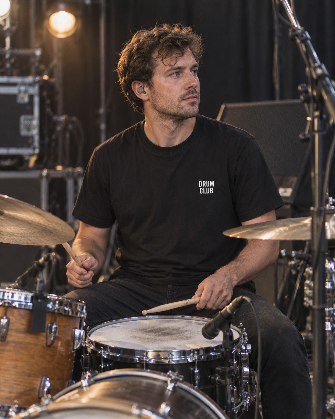 Drummer wearing the black DRUM CLUB Classic Tee during a rehearsal or soundcheck.